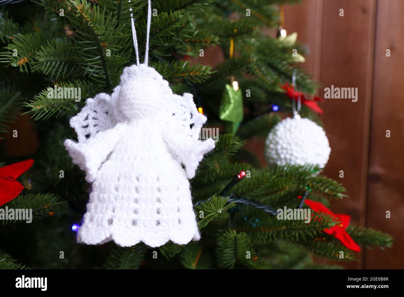 Knitted Christmas angels and other decorations on Christmas tree ...