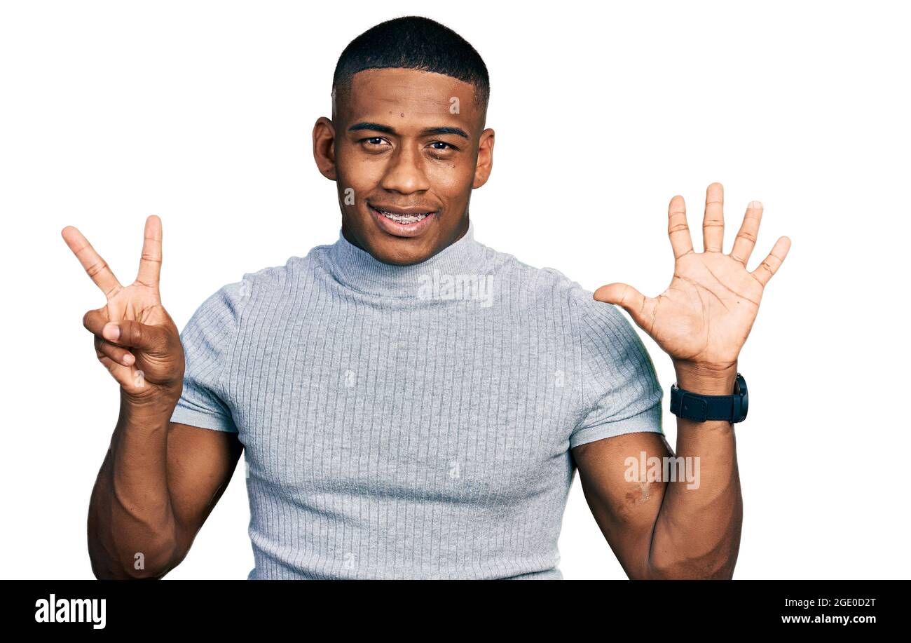 Young black man wearing casual t shirt showing and pointing up with ...
