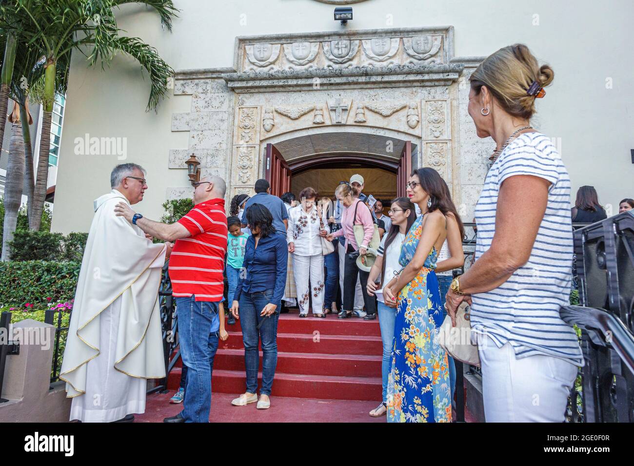 Miami Beach Florida,Saint St. Francis De Sales Catholic Church,members leave leaving depart departing after service,Hispanic man men male,priest greet Stock Photo