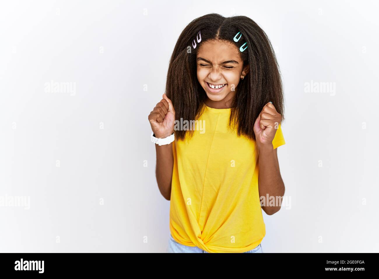 Young african american girl standing over white isolated background ...