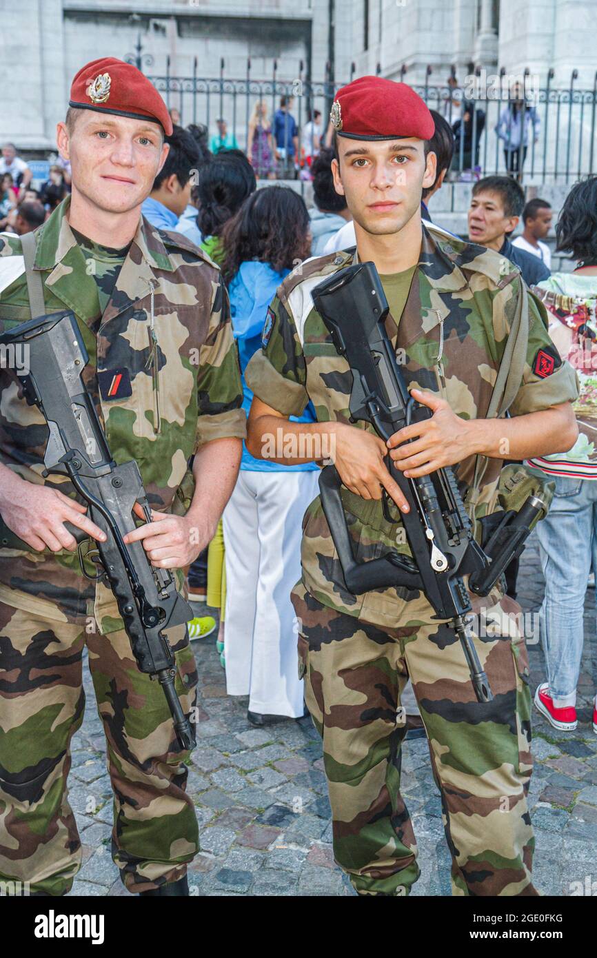Paris France,18th arrondissement Montmatre soldiers military,camouflage uniforms red beret FAMAS assault rifles man men male, Stock Photo