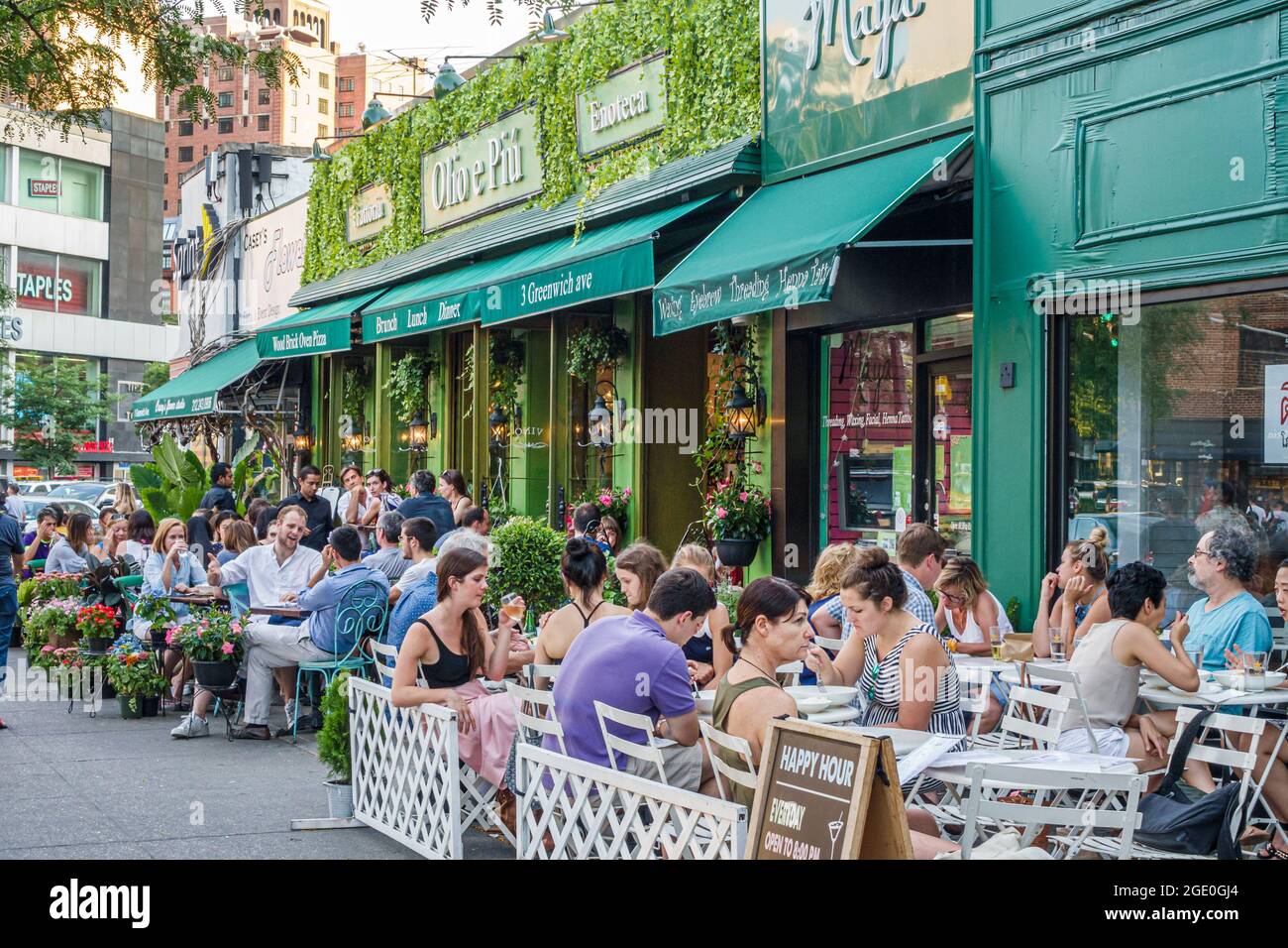 New York City,NY NYC Manhattan,West Village Olio e Piu Italian restaurant,trattoria sidewalk al fresco dining tables outdoor outside exterior crowded Stock Photo