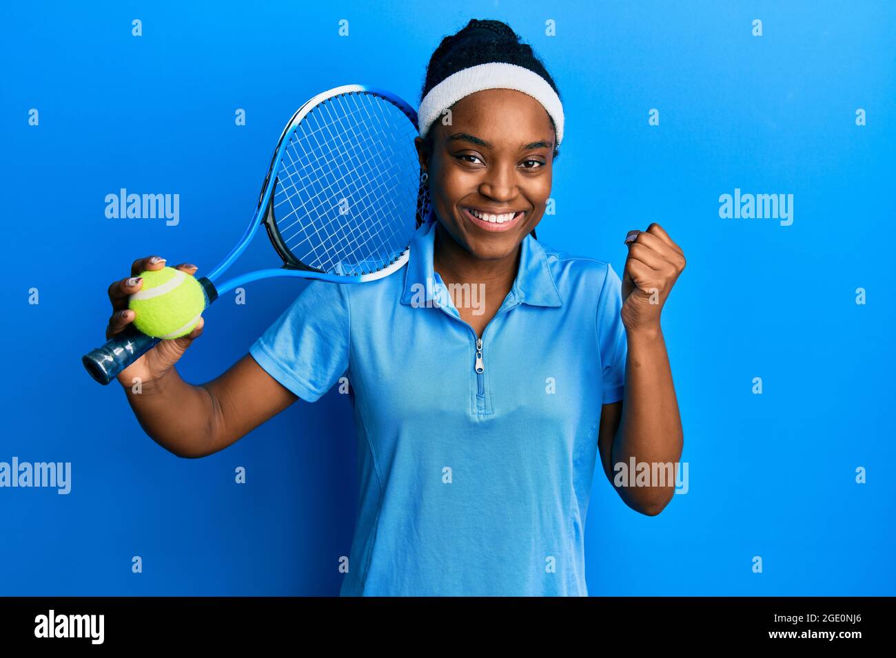 African american woman with braided hair playing tennis holding racket and  ball screaming proud, celebrating victory and success very excited with rai  Stock Photo - Alamy