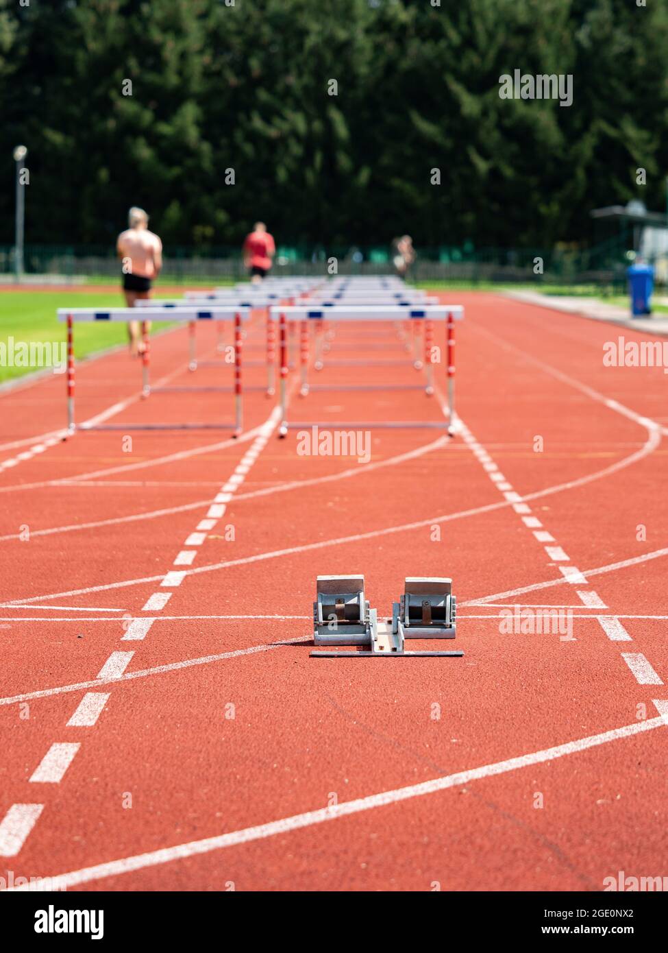 Obstacle course training. Athletics Starting Blocks and red running