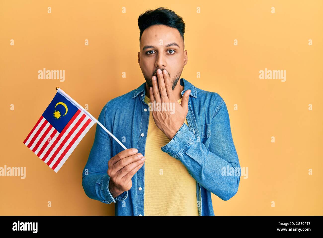 Young Arab Man Holding Malaysia Flag Covering Mouth With Hand Shocked And Afraid For Mistake Surprised Expression Stock Photo Alamy