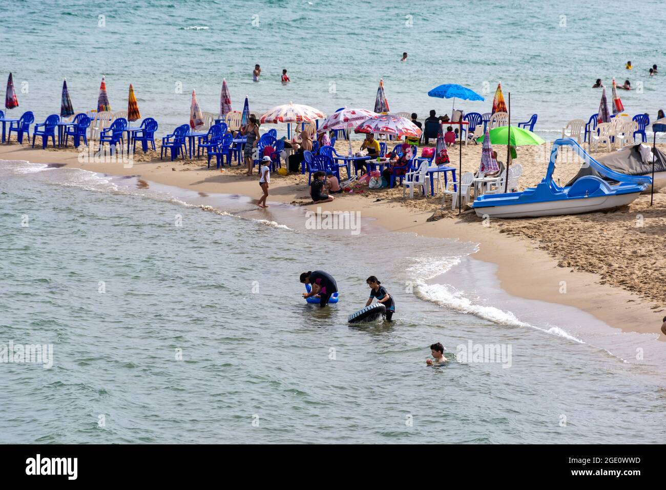 High-angle view of kids playing in the water and having fun on the beach, Skikda, Algeria. Stock Photo