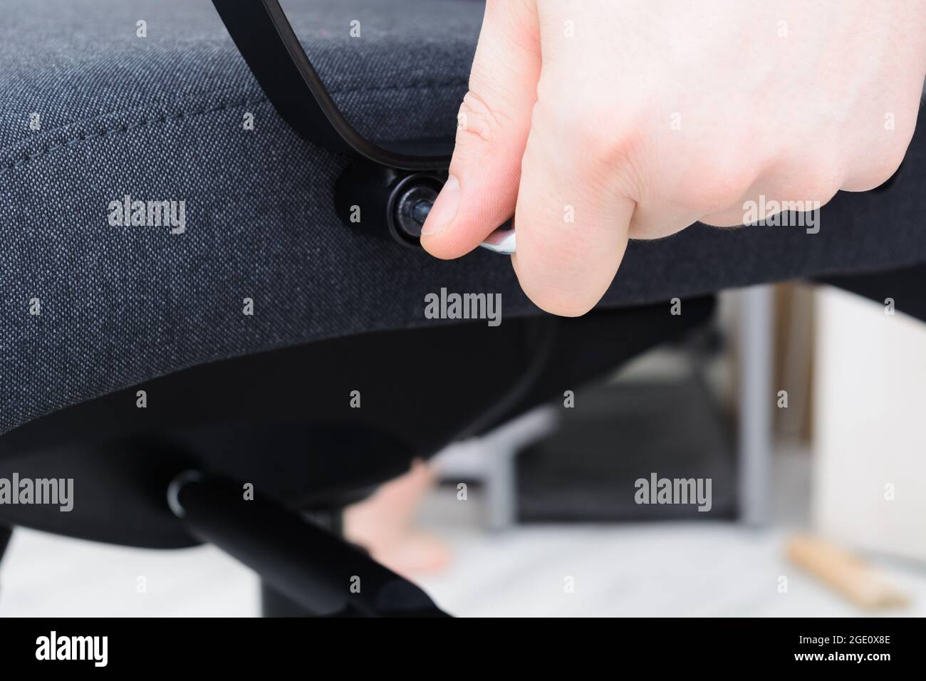Man hands screw chair handle Assembling chair Step by step instructions