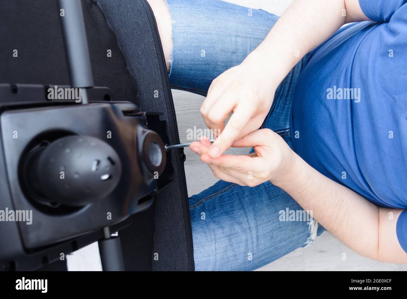 Assembling office chair indoors. Step by step instructions. Step 12 Stock Photo