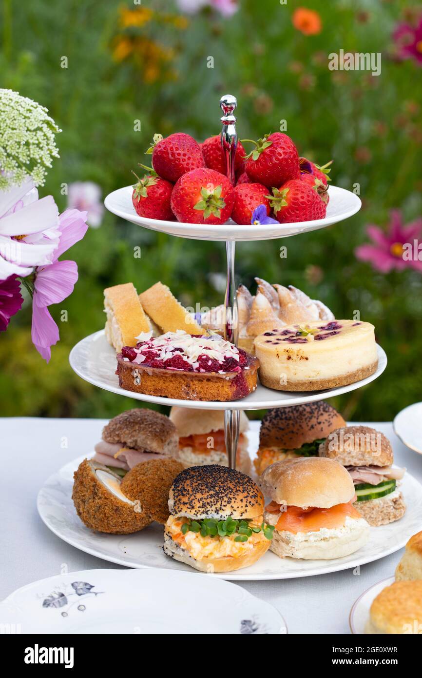 Afternoon tea with cakes and sandwiches Stock Photo - Alamy