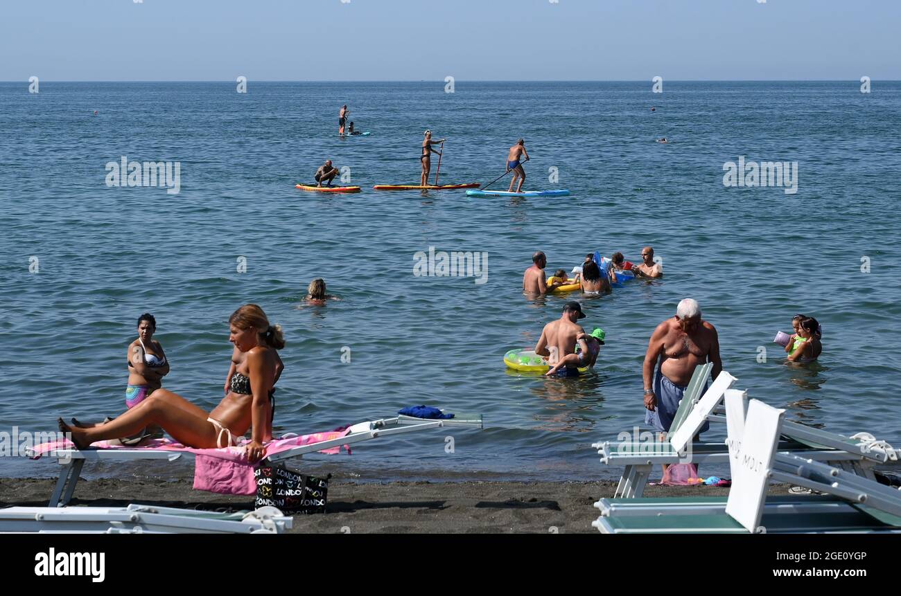Ladispoli, Italy. 15th Aug, 2021. People enjoy leisure time at the seaside in Ladispoli near Rome, Italy, on Aug. 15, 2021. The latest heatwave has sparked heat and humidity warnings across much of southern Europe, but Italy may be the hardest-hit part of the continent. Credit: Alberto Lingria/Xinhua/Alamy Live News Stock Photo