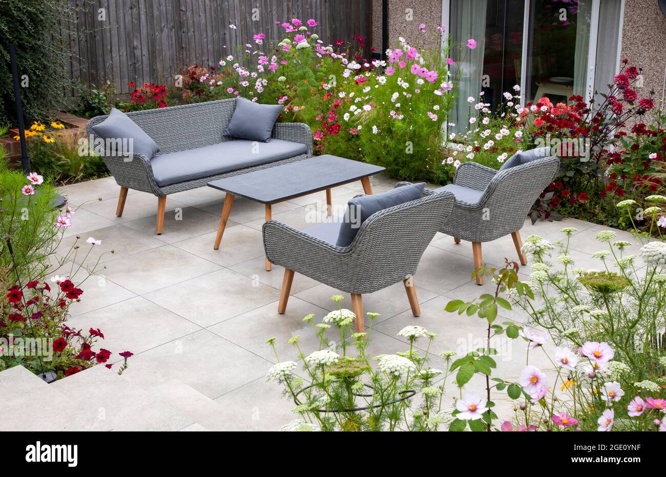 Outdoor living, terrace in the garden with flowers Stock Photo