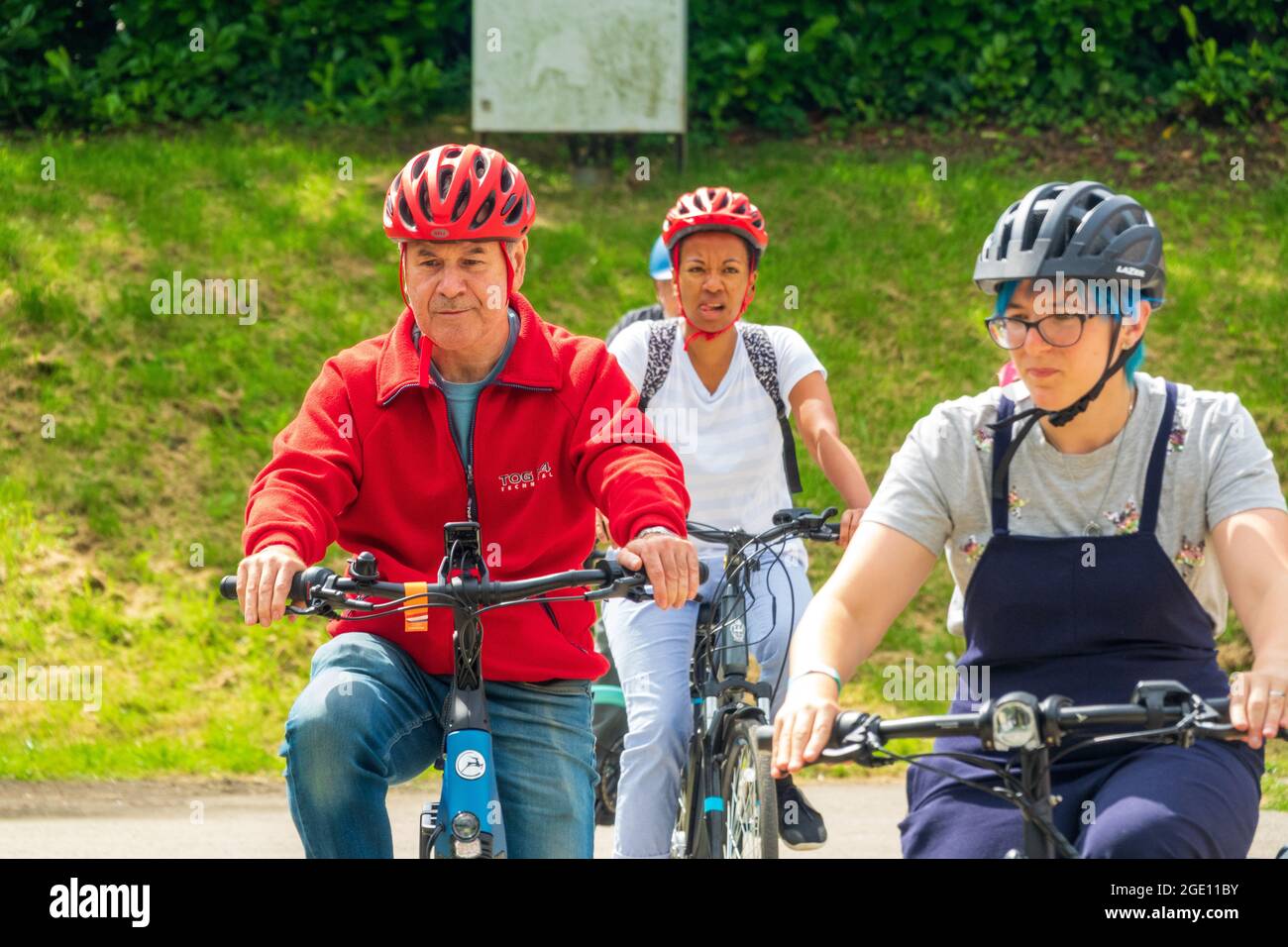 Three people cycling on e-bikes or electric bikes at The Cycle Show ...