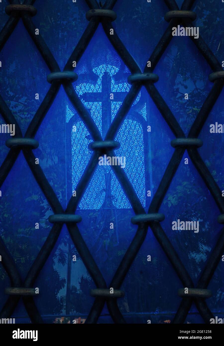 Blue stained glass window behind bars against the light Stock Photo Alamy