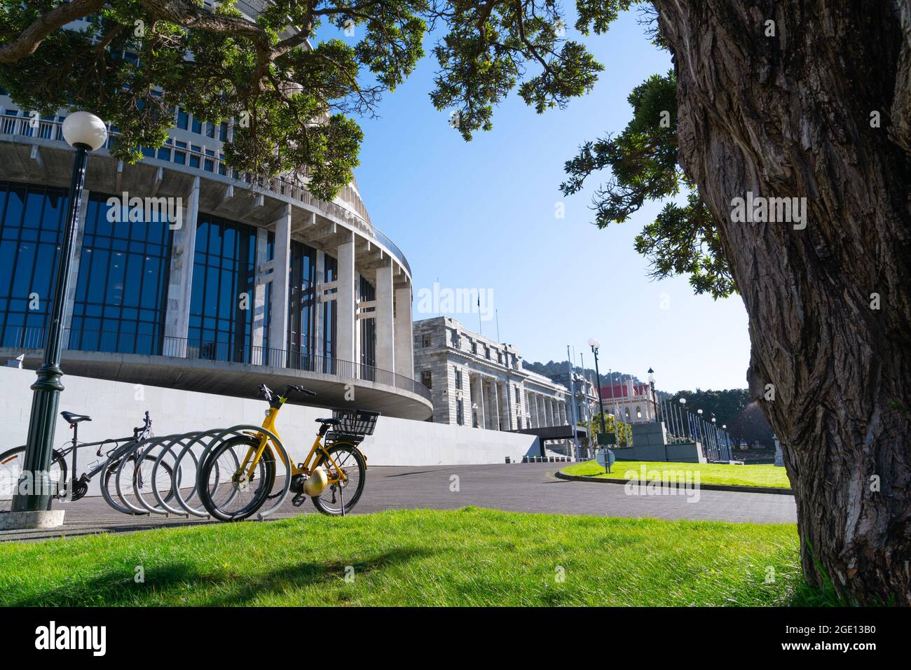 Bicycles outside New Zealand government buildings including circular landmark known as Beehive, Wellington. Stock Photo