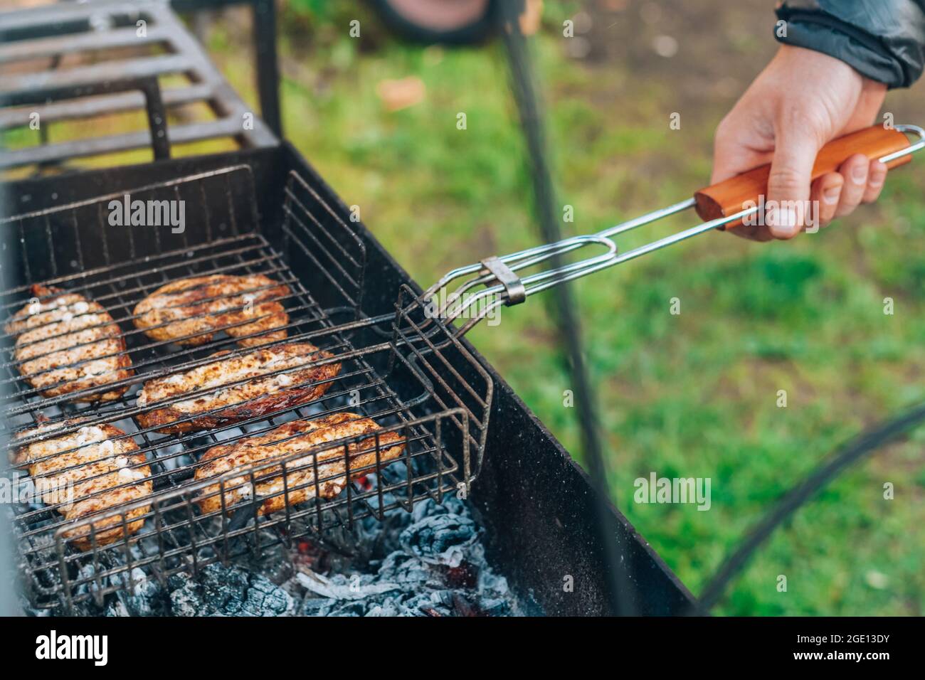 Cook turns grill meat on hi-res stock photography and images - Alamy
