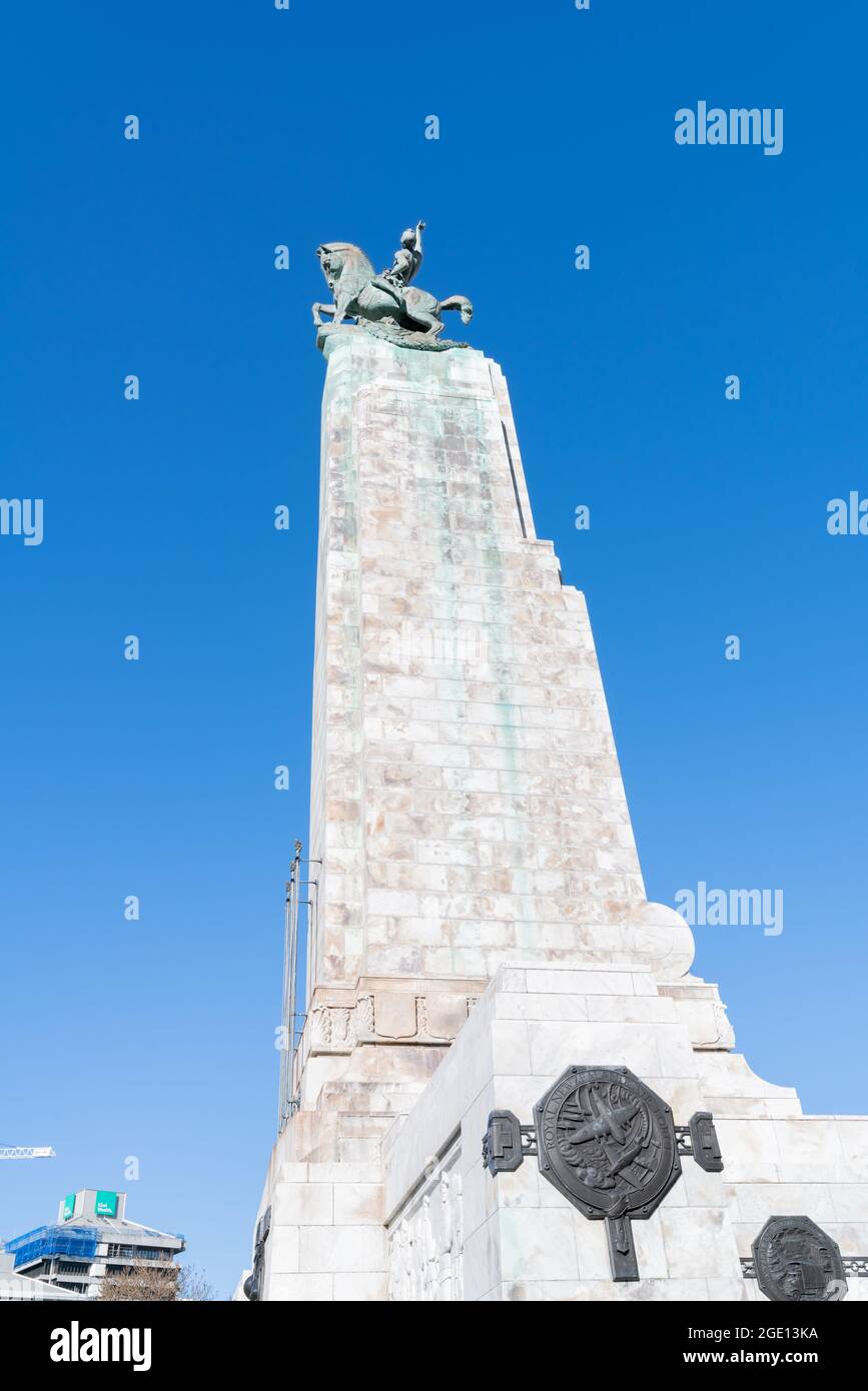 New Zealand National War Memorial or cenotaph in downtown Wellington near  Beehive towers high above  street into blue sky above. Stock Photo