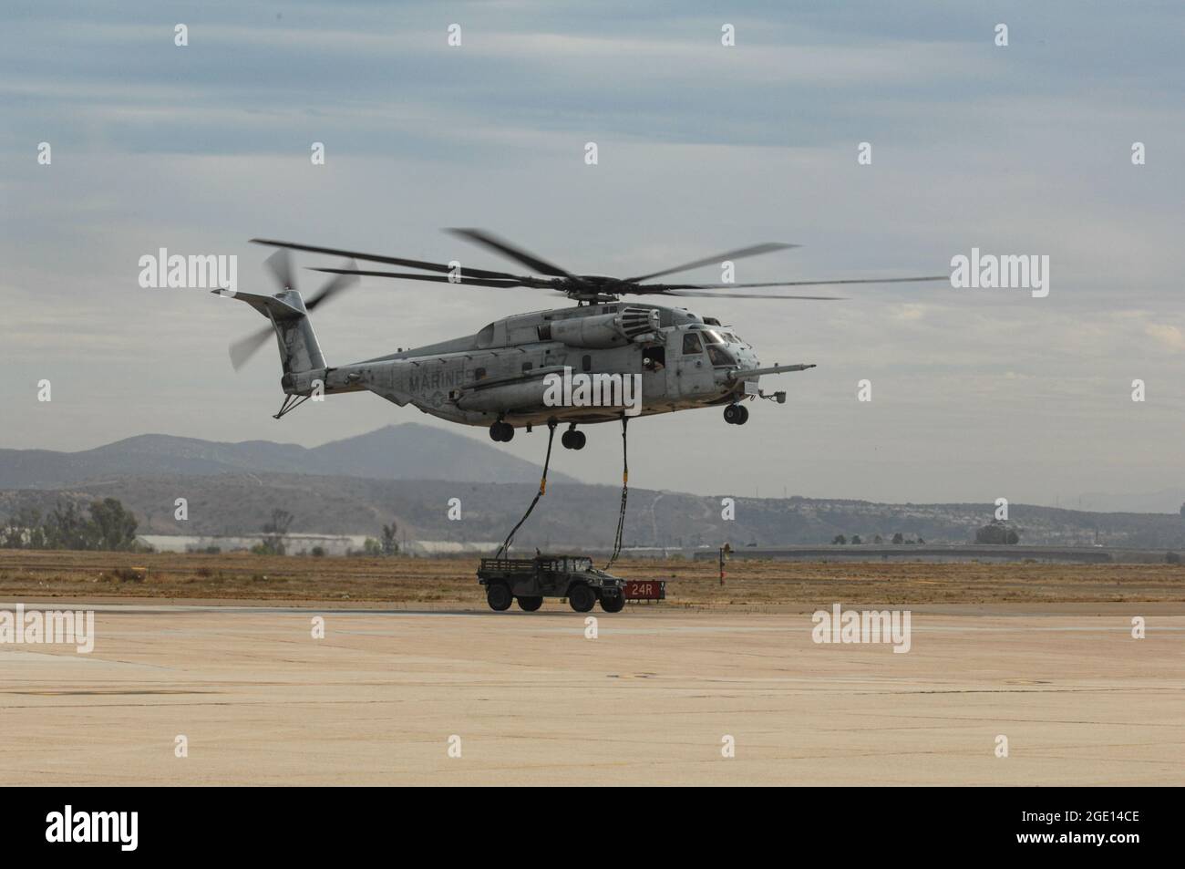 USMC CH-53E Super Stallion sets a HUMMVEE on target in the LZ Stock Photo
