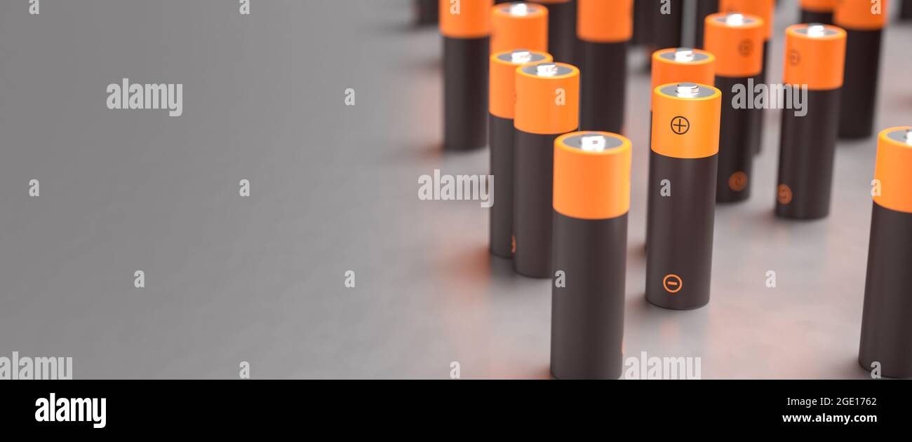 Several AA batteries on a metal surface. Shallow depth of field. Web banner format with copy space Stock Photo