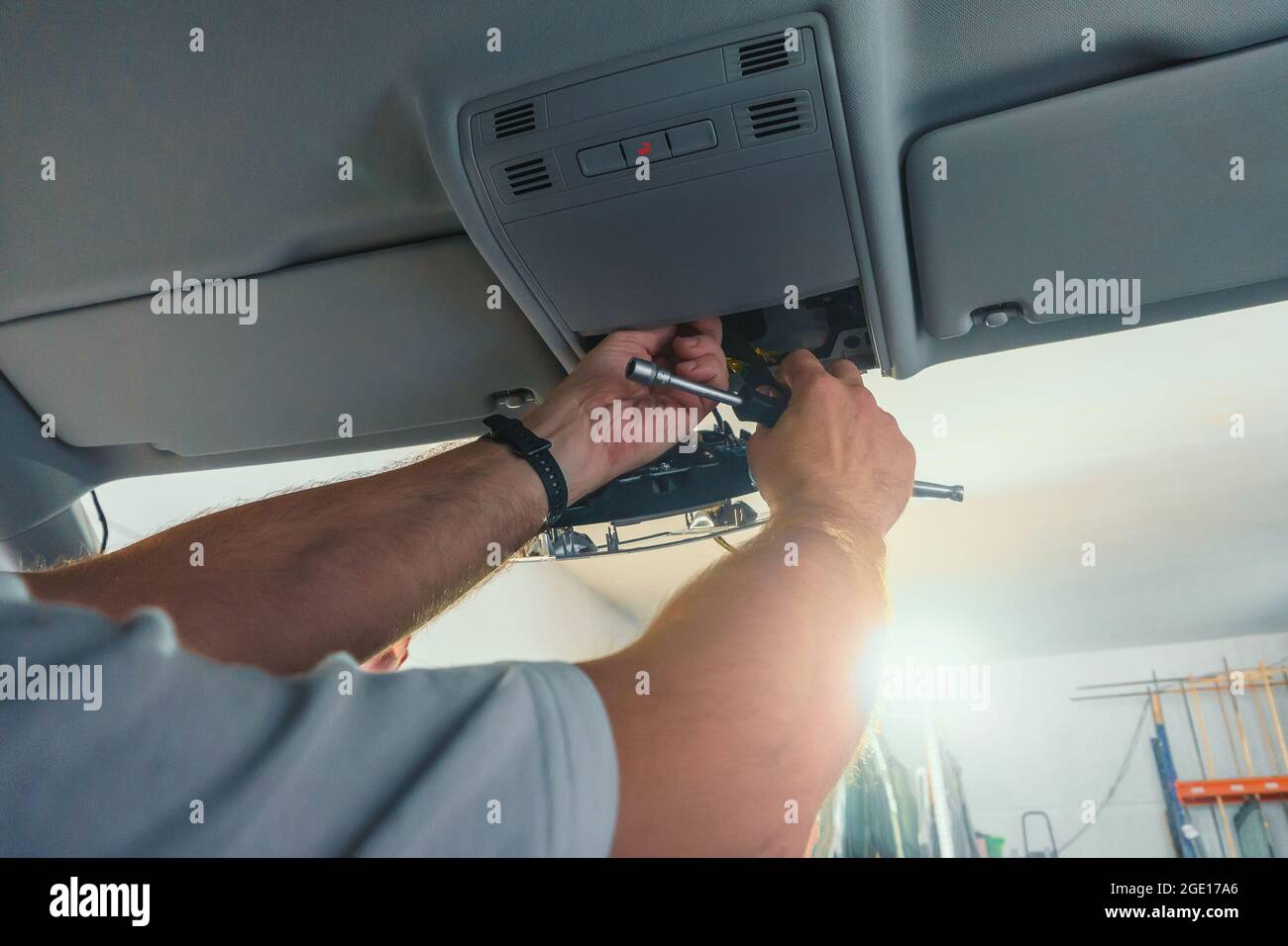 Car repair. Serviceman repairs electrical wiring inside car. Replacing