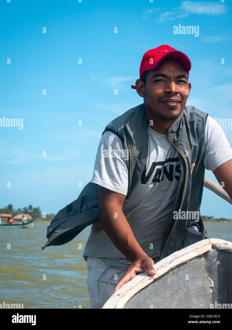 Riohacha, La Guajira, Colombia - May 30 2021: Young Indigenous Black Latin Man Smiles Pushing the Boat with the Wind on his Face Stock Photo