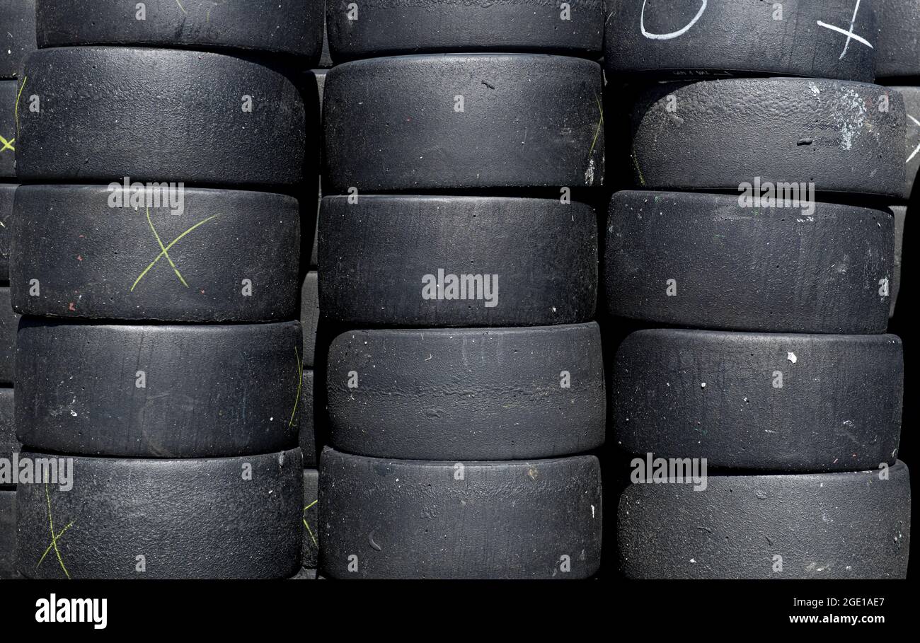 Large group of motorsport used and scratched racing tire heap set full frame background Stock Photo