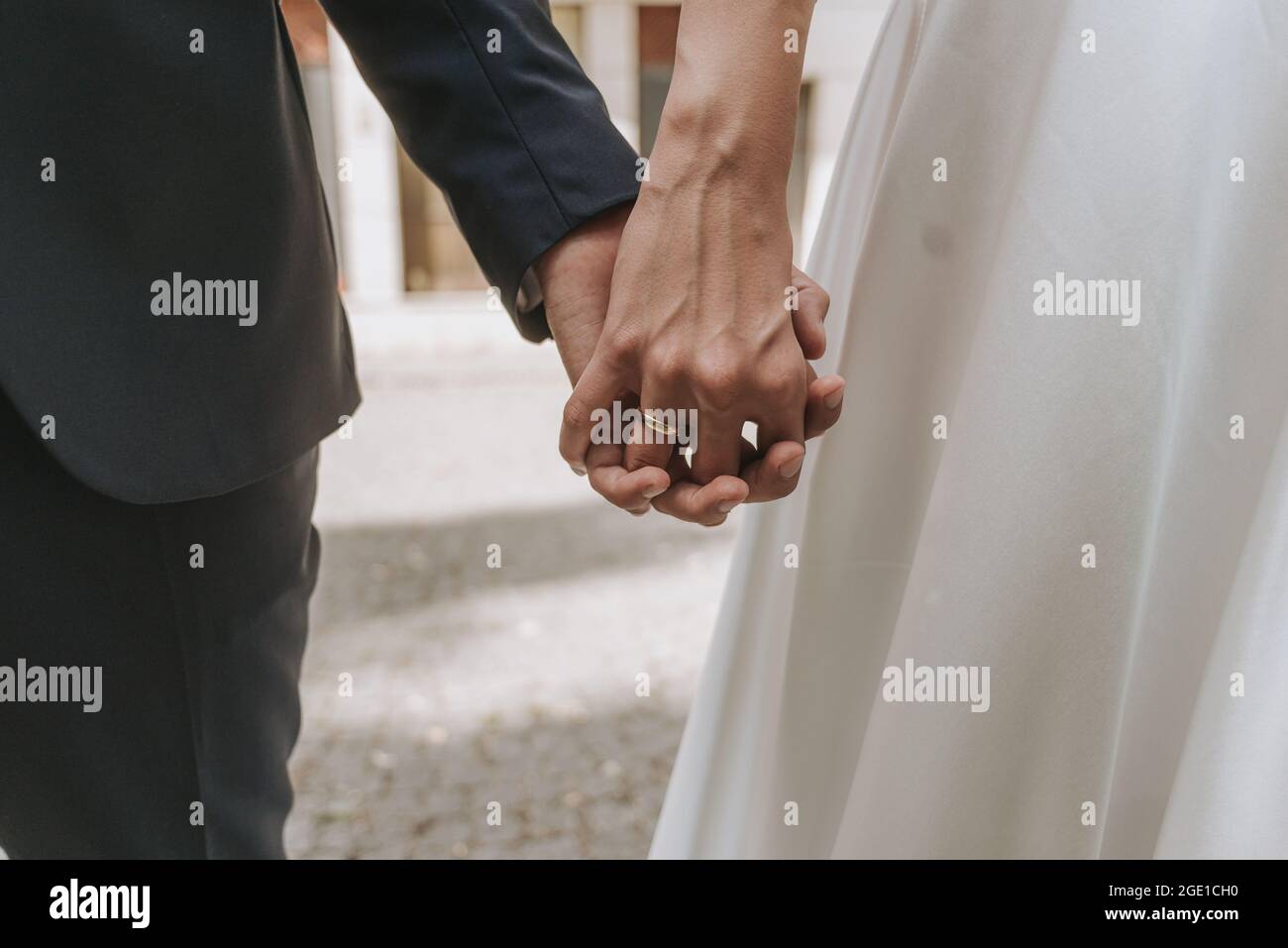 bride and groom holding hands close up Stock Photo