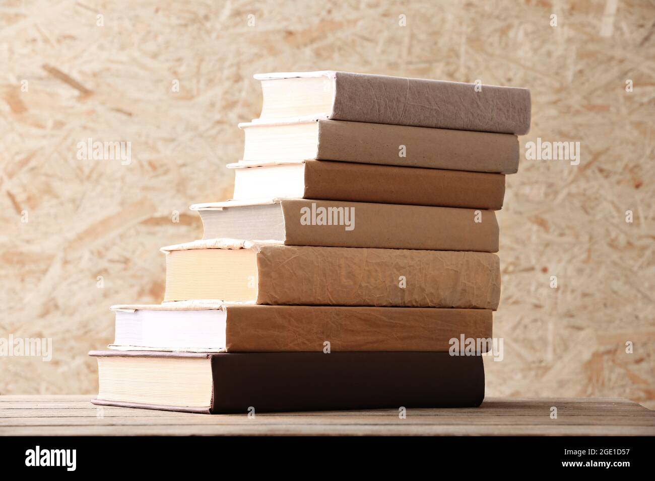 Stack of books on wooden hardboard background Stock Photo Alamy