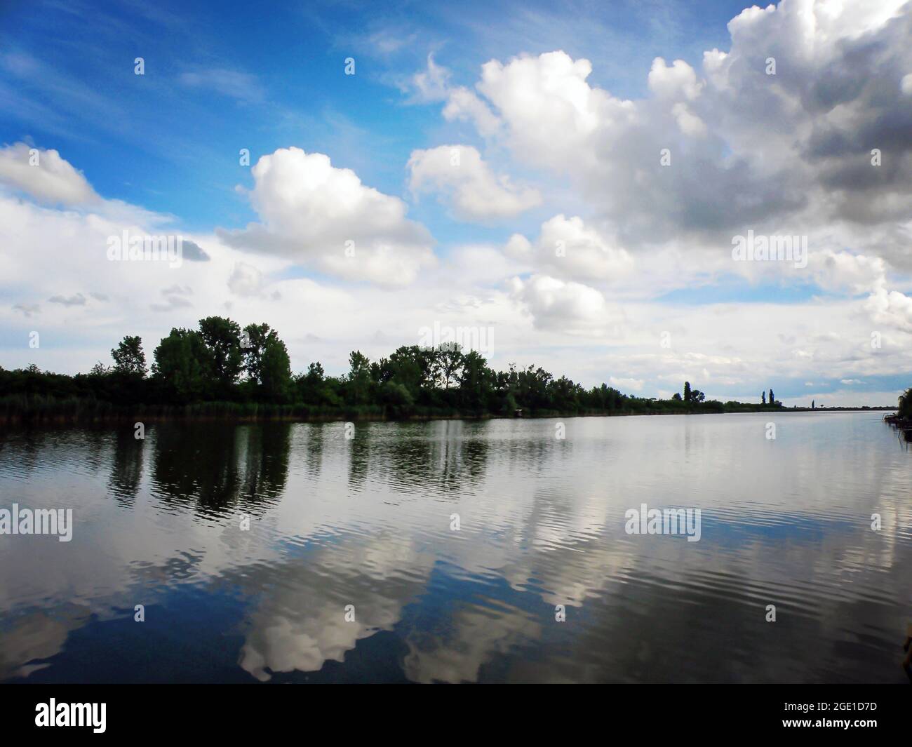 Lake with blue sky and clouds reflecting in tranquil River Stock Photo ...