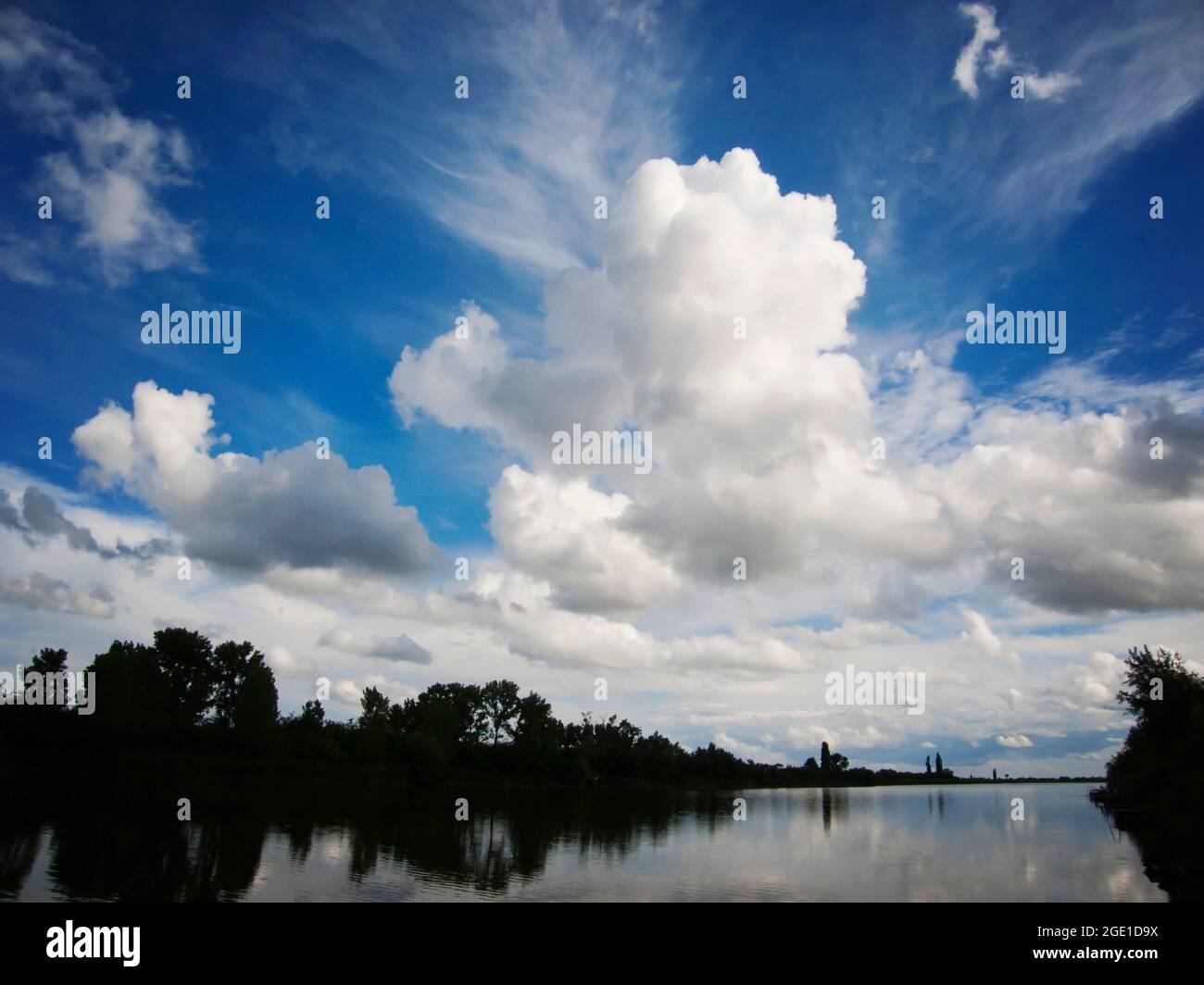Lake with blue sky and clouds reflecting in tranquil River Stock Photo ...