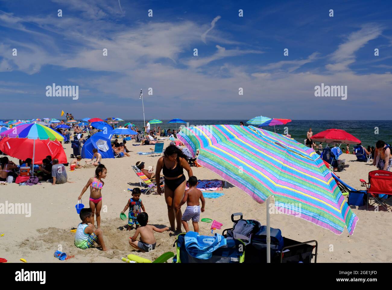 Large crowds enjoying a sunny beach day at Seven Presidents Oceanfront Park in Long Branch along the New Jersey Shore Stock Photo