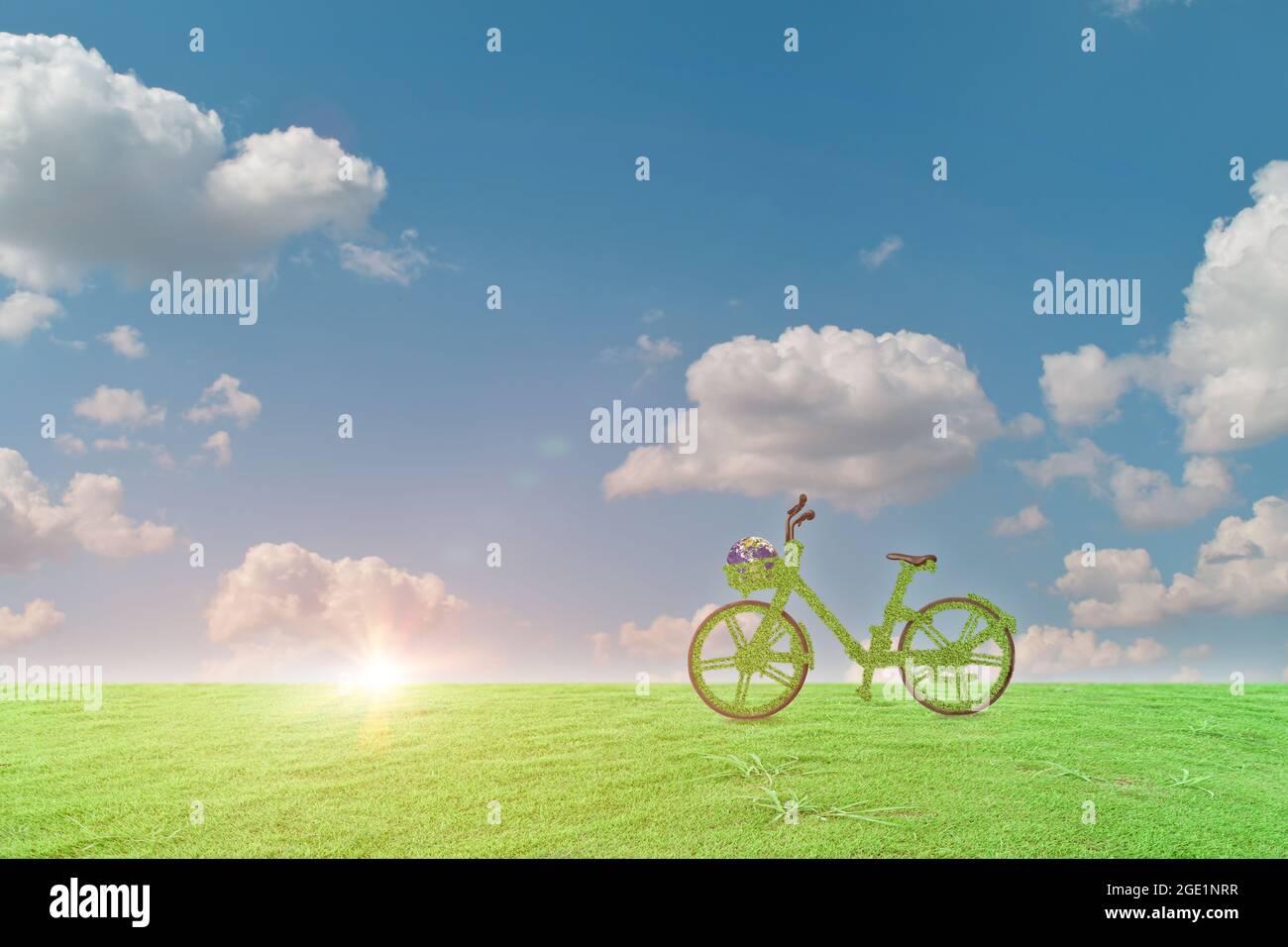 Green ecological bicycle with globe on grass field and blue sky background. Environment and earth day concept. image furnished by NASA Stock Photo