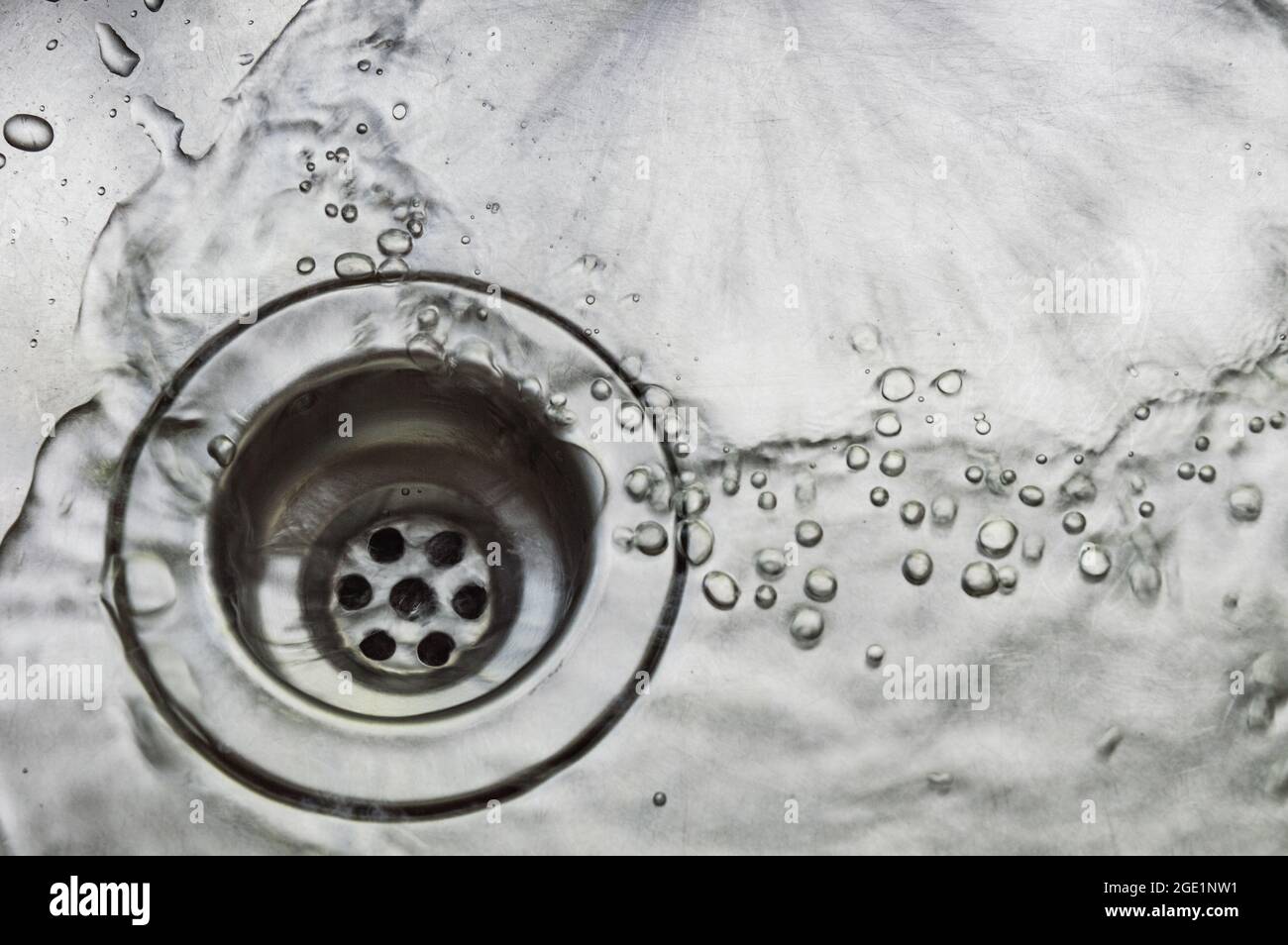 a wet dirty sink after washing many dishes photo may had noise and gain
