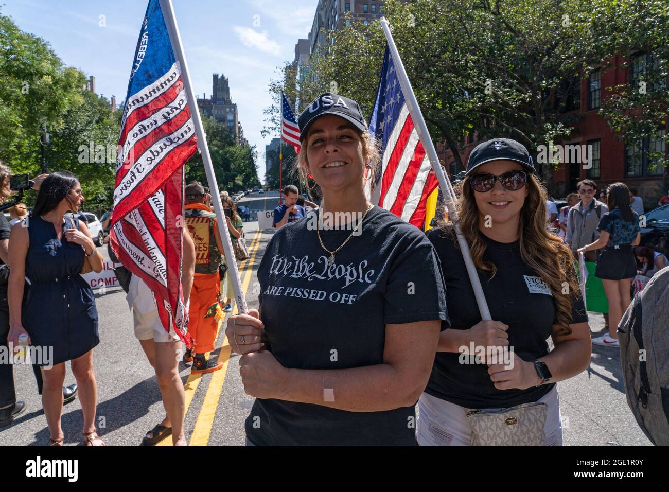 NEW YORK, NY - AUGUST 15: Women hold flags at a Republicans Rally against COVID vaccine mandates outside of Gracie Mansion on August 15, 2021 in New York City.   NYC vaccine mandate starts Monday, August 16th.   Proof of coronavirus (COVID-19) vaccination will be required to attend indoor restaurants, gyms, and entertainment venues with enforcement of the mandate to begin on September 13th. Credit: Ron Adar/Alamy Live News Stock Photo