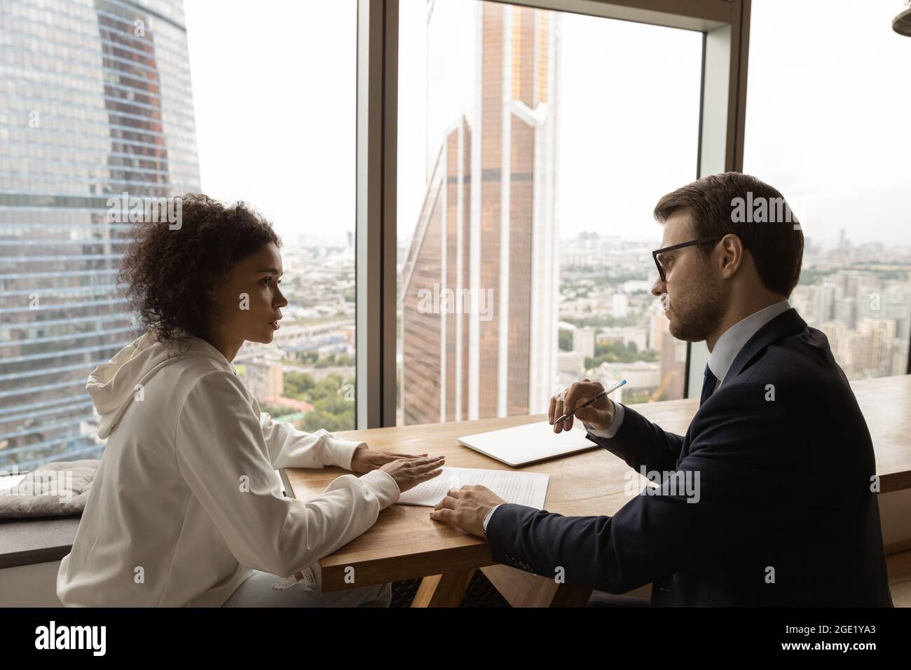 African applicant communicates with employer during interview in modern office Stock Photo