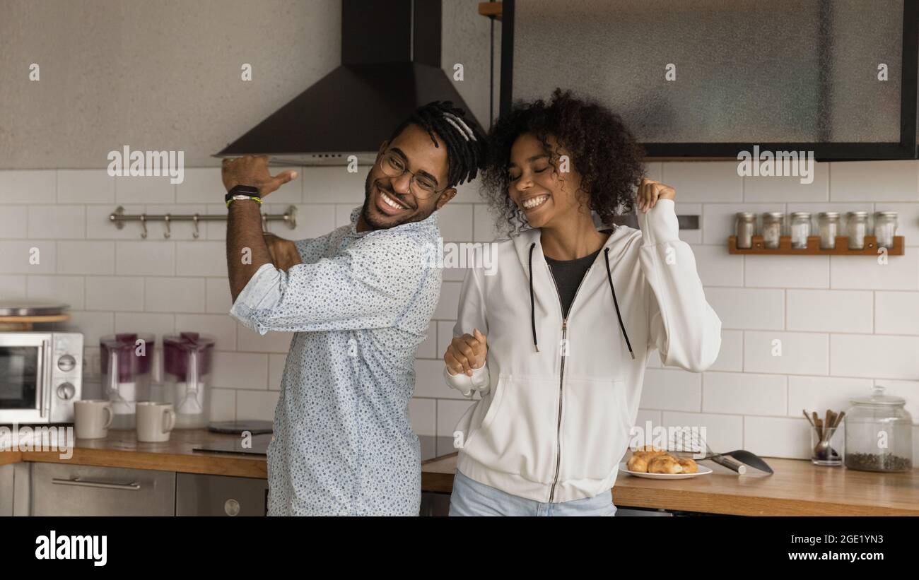 Happy African couple dancing together in modern kitchen Stock Photo - Alamy