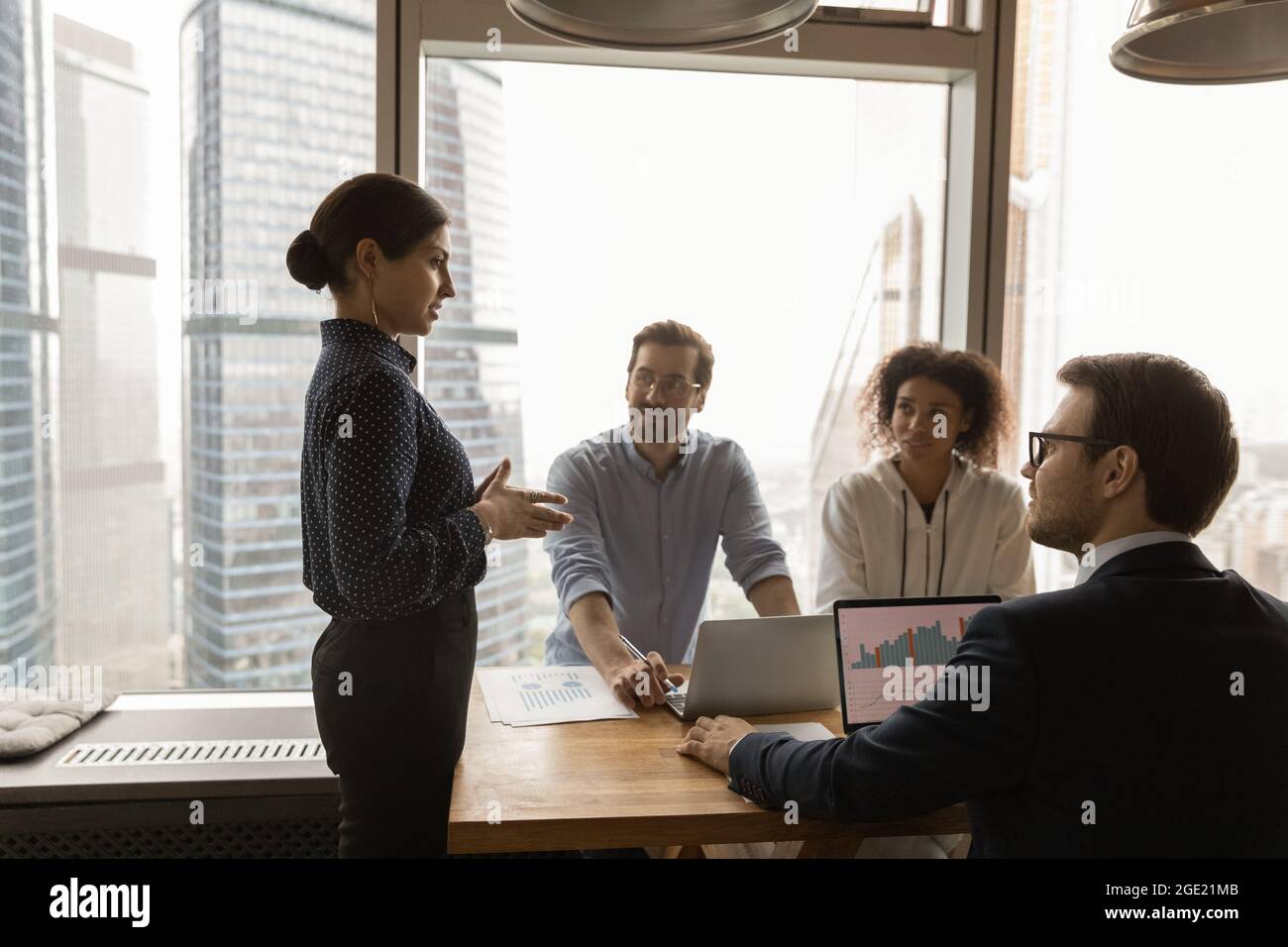 New Management Group Leader presenting new management corporate strategy to multiethnic team ...