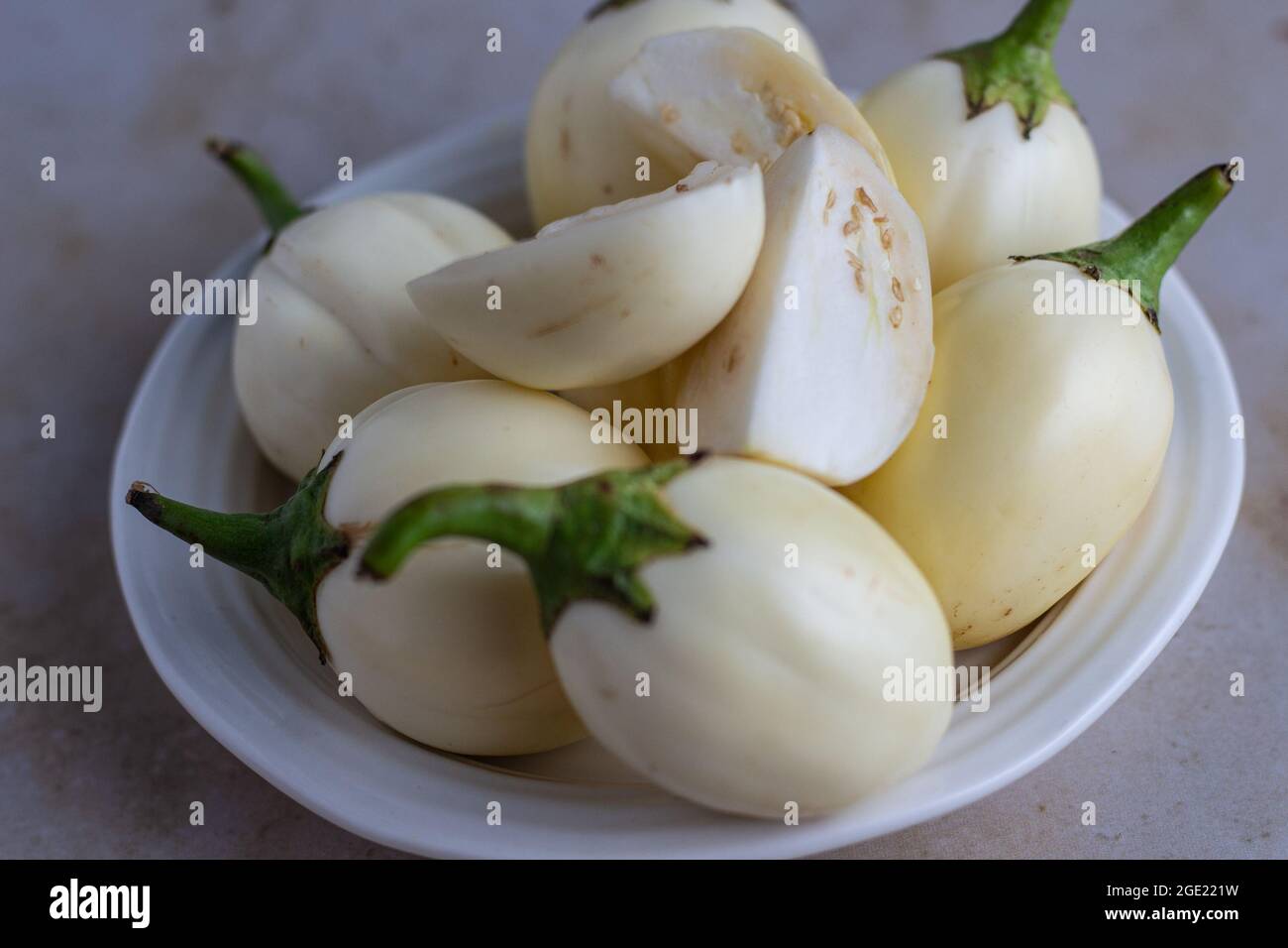 African White Garden Egg / Eggplant with some sliced in quarters Stock