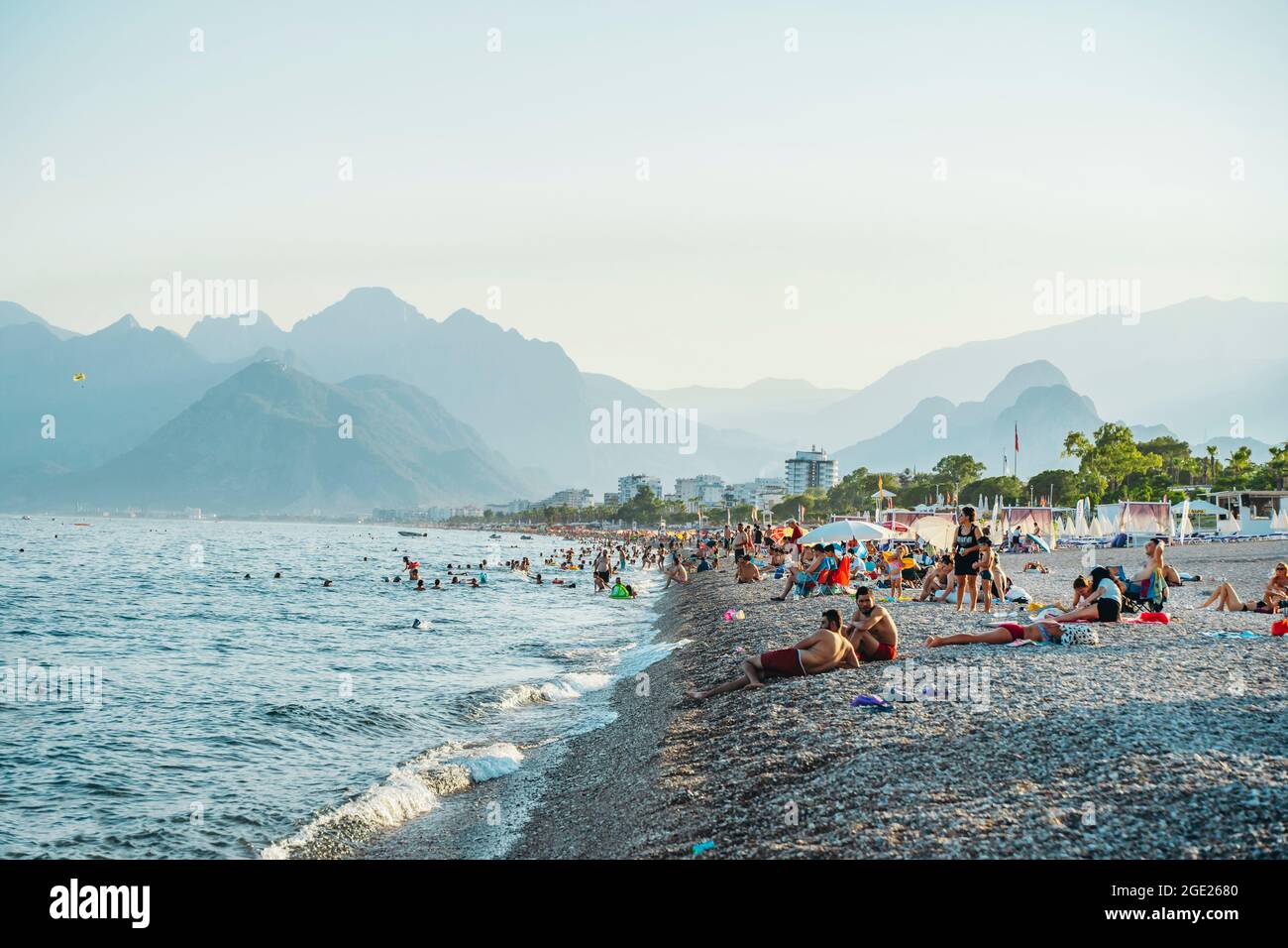 Antalya, Turkey - 12 August 2021: Konyaalti beach in Antalya. Long Turkish beach on the Mediterranean sea in warm sunny summer weather. Rest of tourists at the seaside resort. High quality photo Stock Photo