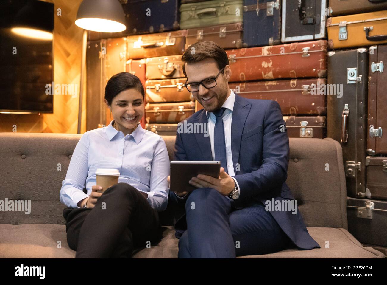 Multiracial colleagues have fun use tablet sit in office Stock Photo