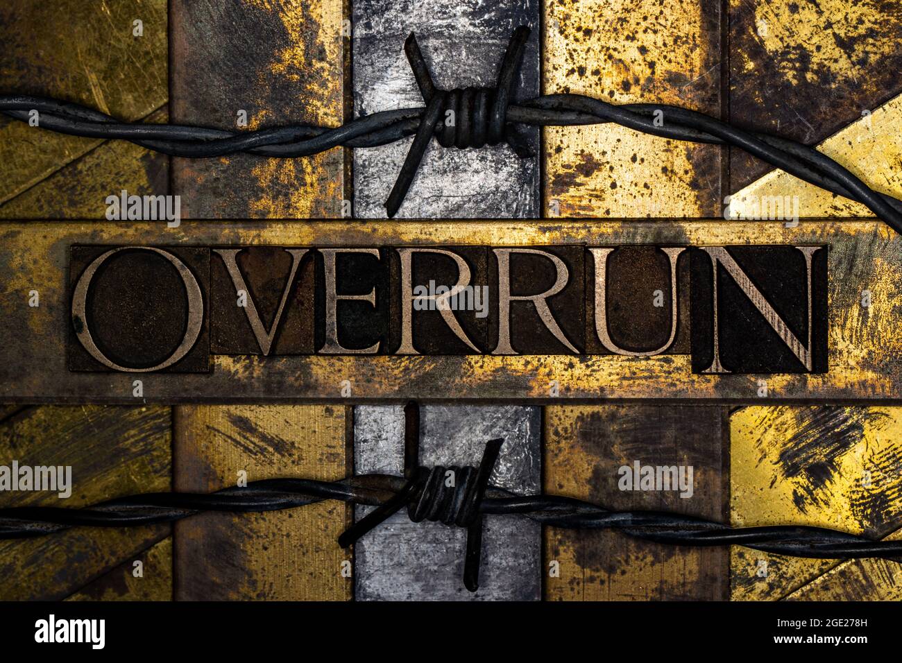 Overrun text message on textured grunge copper and vintage gold background  with barbed wire Stock Photo - Alamy