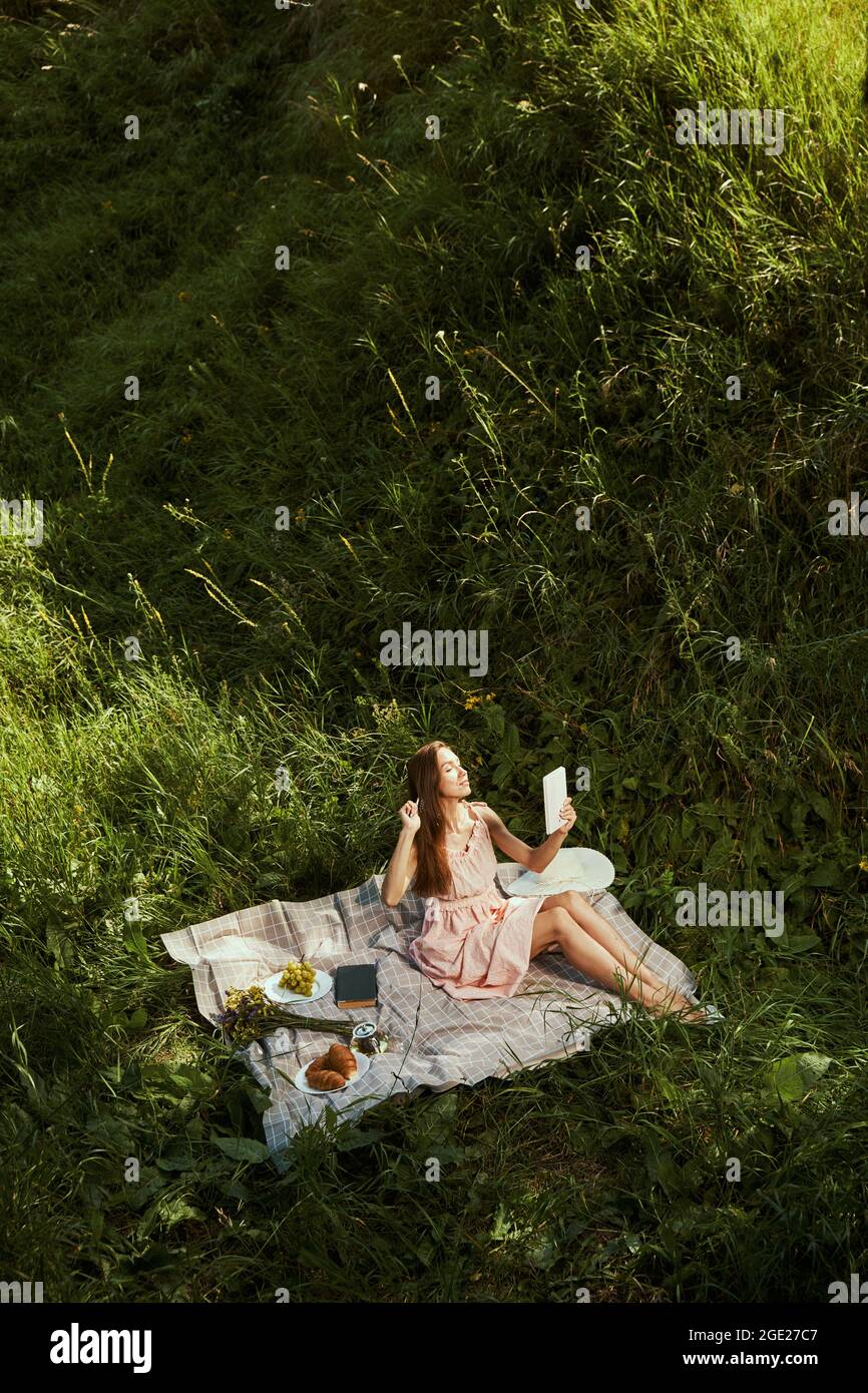 Beautiful lady combing her hair before the photo session Stock Photo