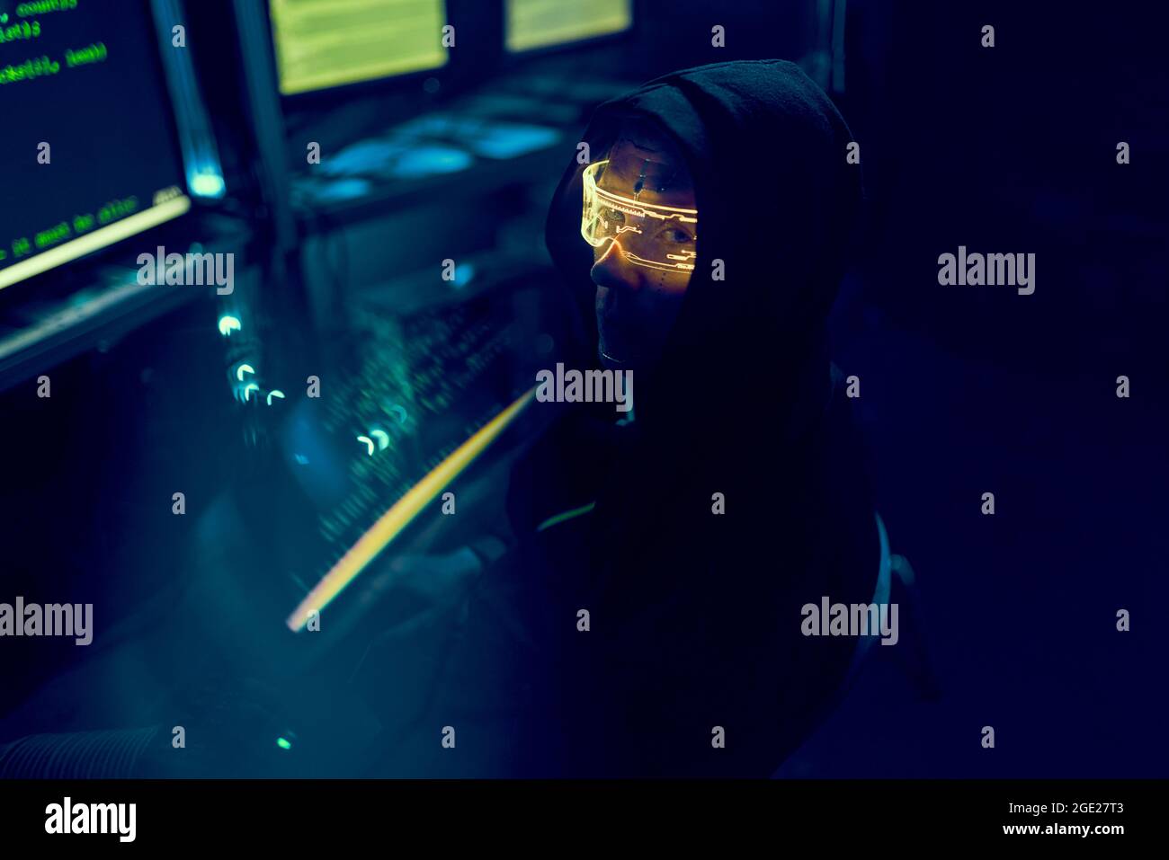 Cyber hacker breaks into databases to obtain information using a computer. Cybercrime and data security concept. Stock Photo