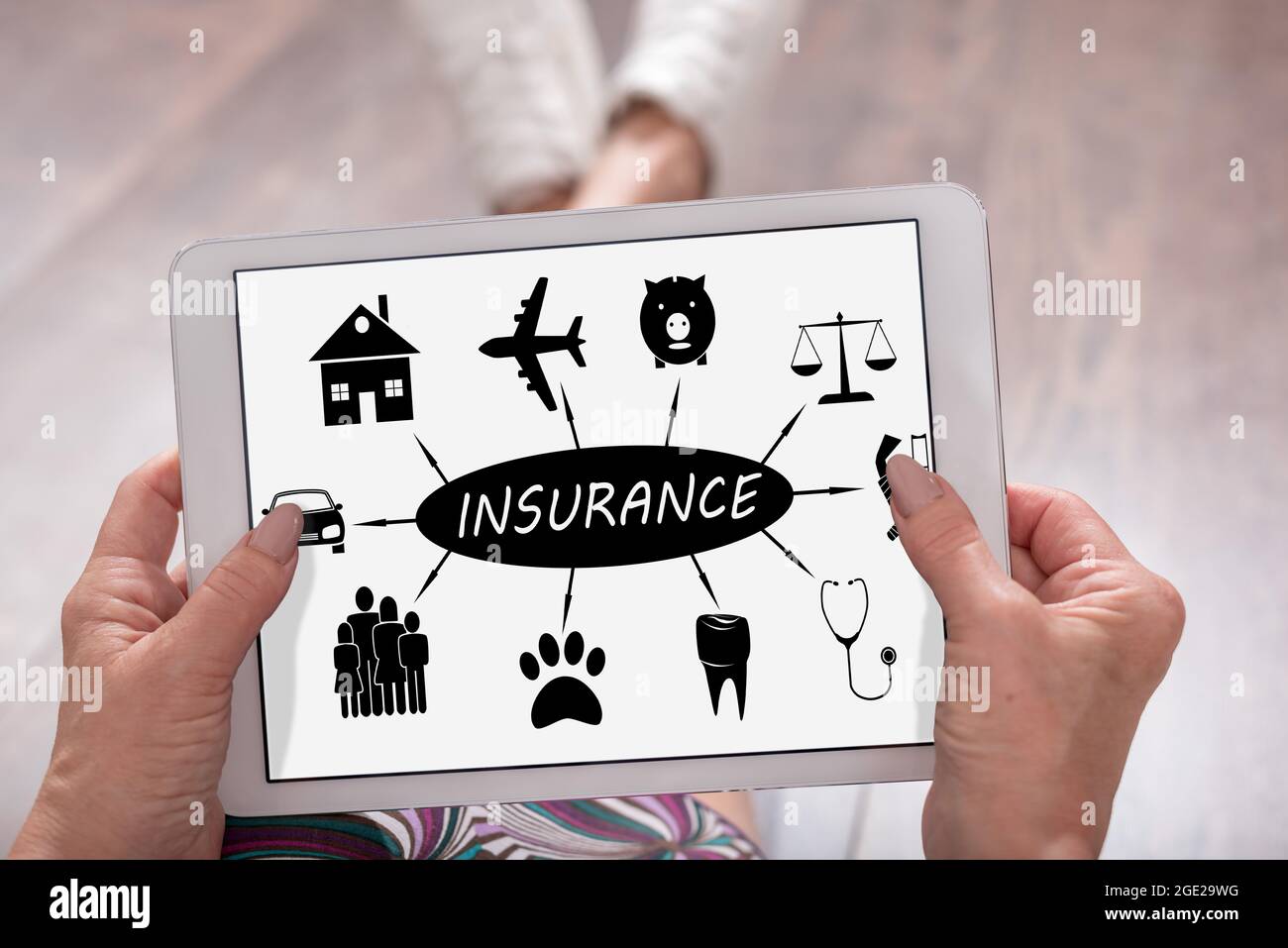 Insurance concept shown on a tablet held by a woman Stock Photo - Alamy