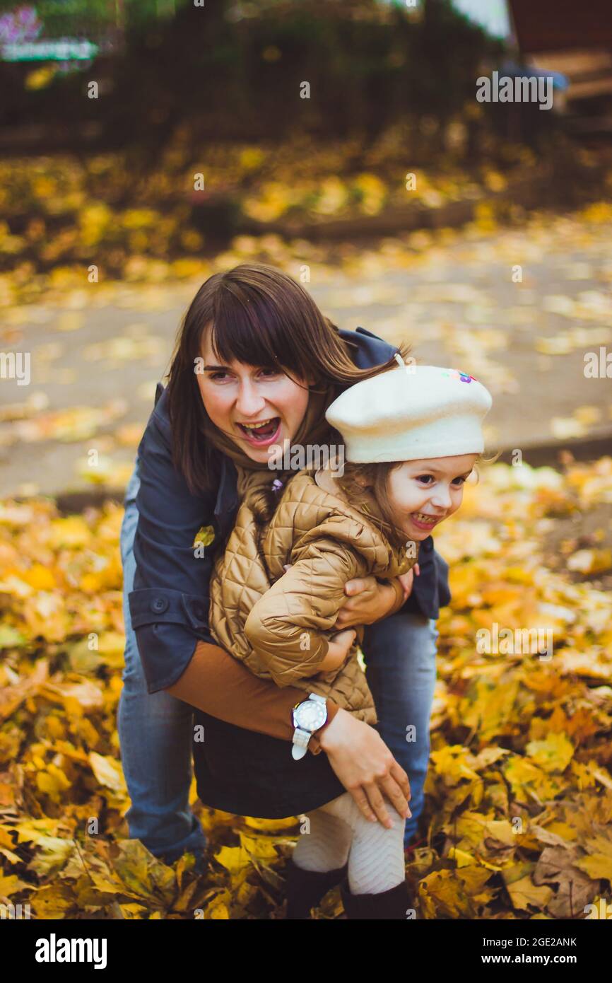 Young mother and her daughter have fun at autumn Stock Photo - Alamy