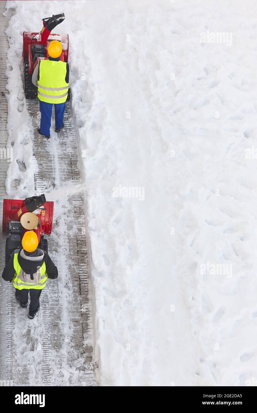 Sidewalk cleared by road worker in special attire, removing snow after  snowstorm. AI Generated 29294325 Stock Photo at Vecteezy