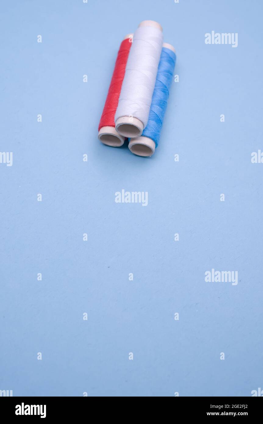 Vertical closeup of threads on the aesthetic blue background Stock ...