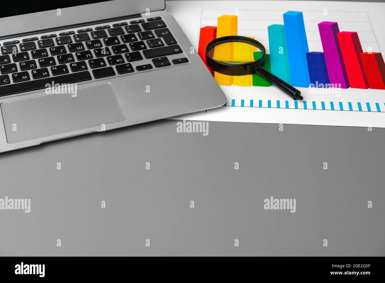 Financial report and laptop on business desk Stock Photo - Alamy