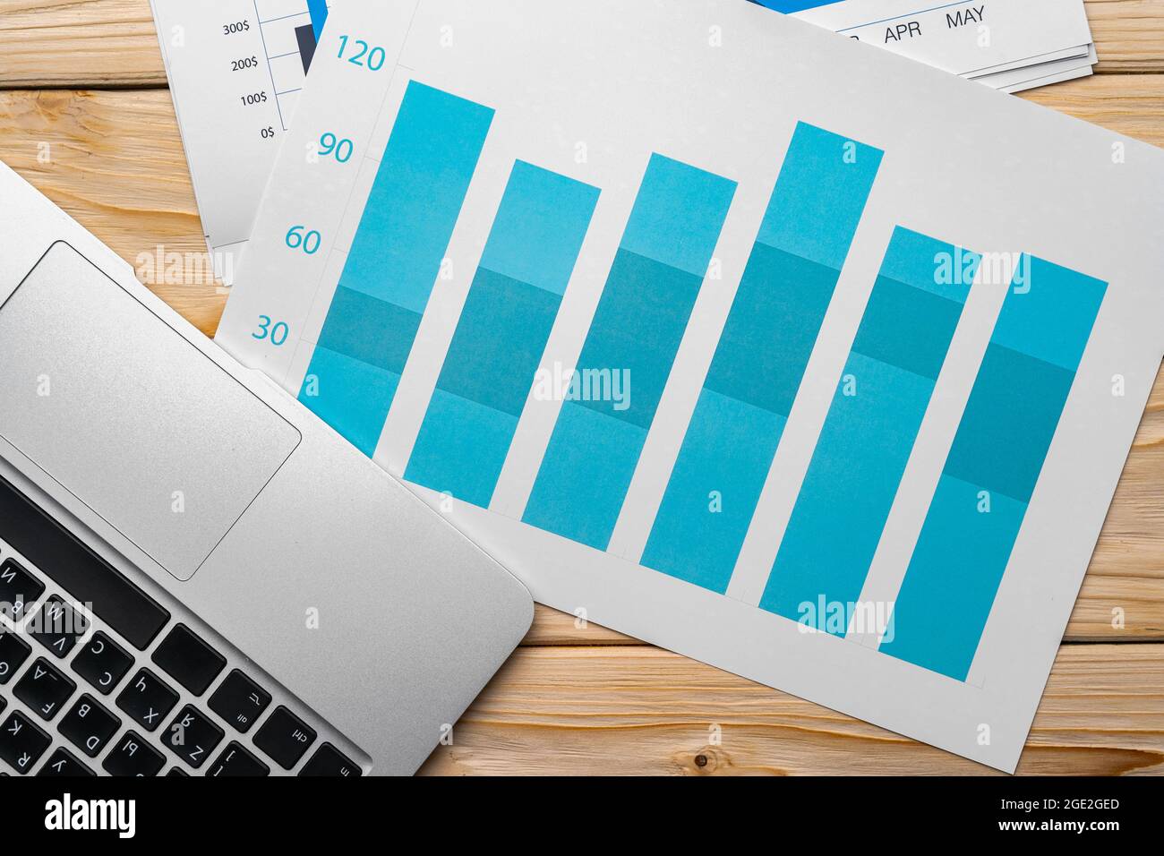 Financial report and laptop on business desk Stock Photo - Alamy