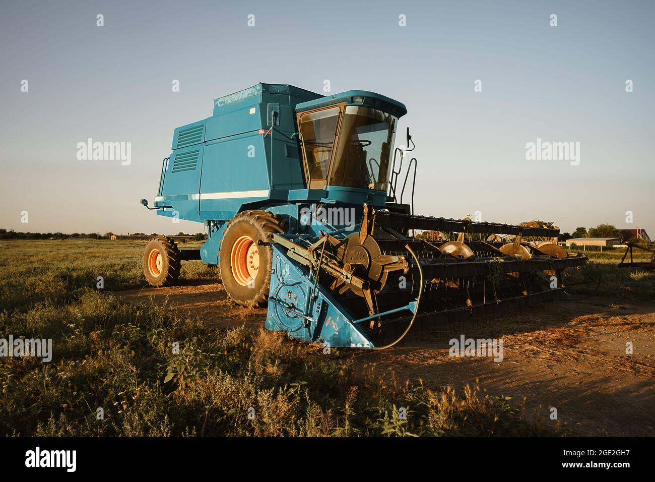 Blue combine harvester agriculture machine harvesting in a field Stock