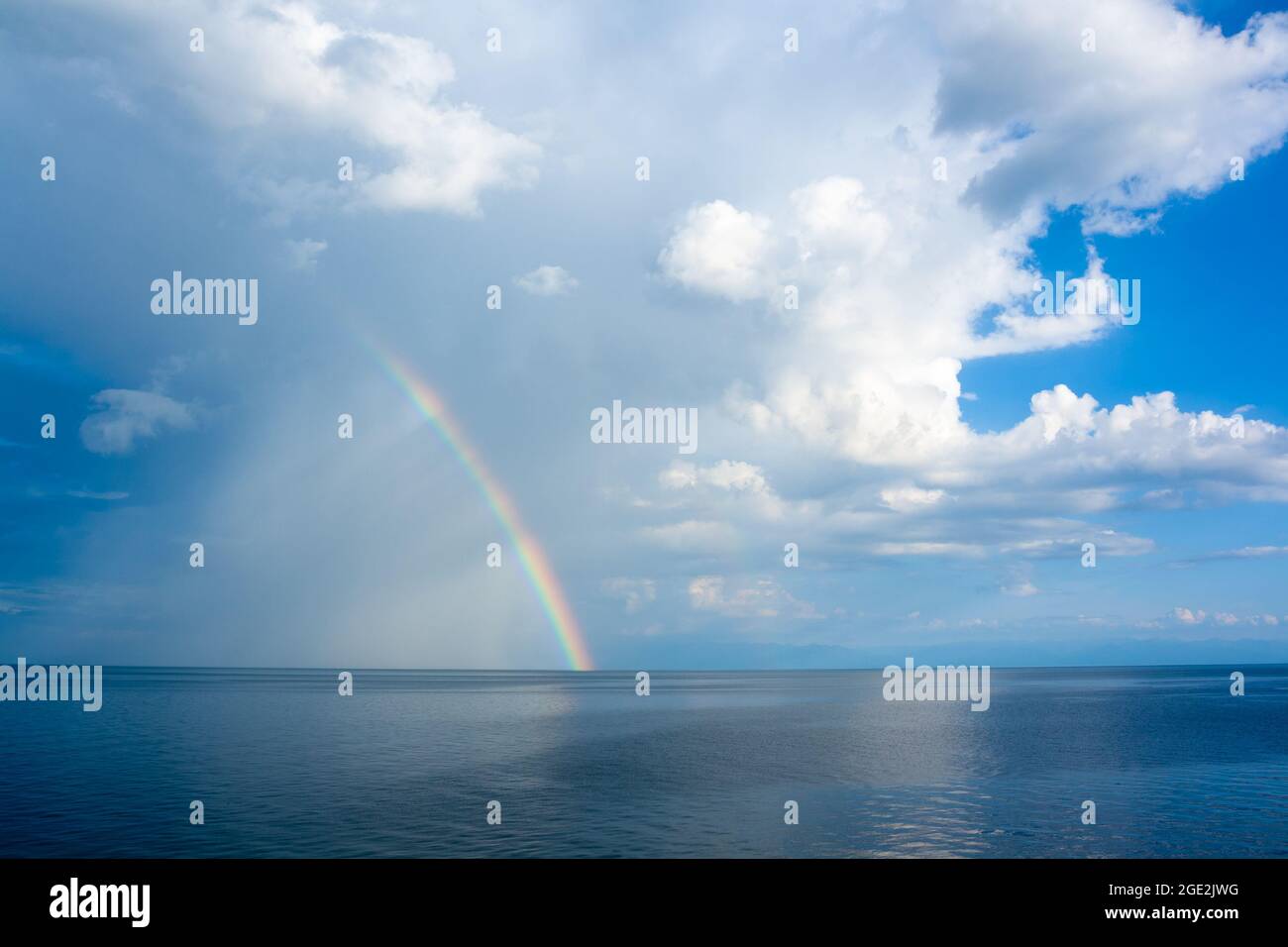 Rainbow in cumulus clouds hi-res stock photography and images - Alamy